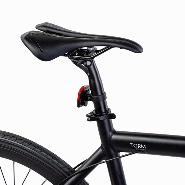 Sleek black saddle of the Oolter Torm electric bike with integrated rear light and seat post.