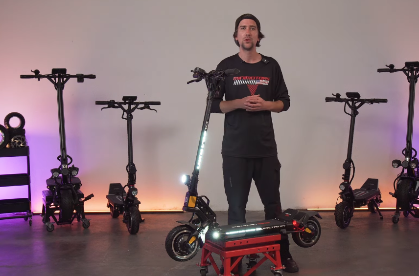 Electric scooter Dualtron Mini Special LB Dual Motor video thumbnail where a man is standing behind the scooter.