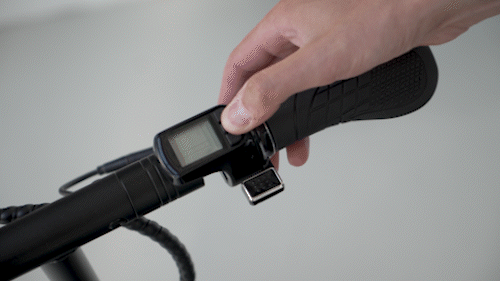 Gif of Electric scooter Gpad Joyride handlebar and thumb activating the lcd display