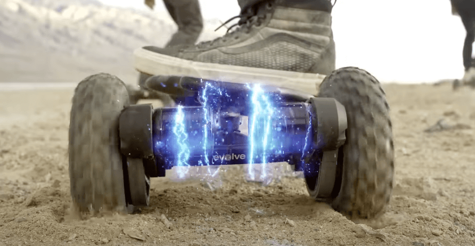 Close-up of Evolve GTR 2 Bamboo All Terrain electric skateboard riding through sand with power animation