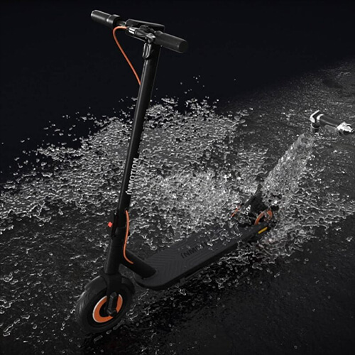 Inmotion Climber electric scooter being demonstrated with its water resistance and durable build under wet conditions.