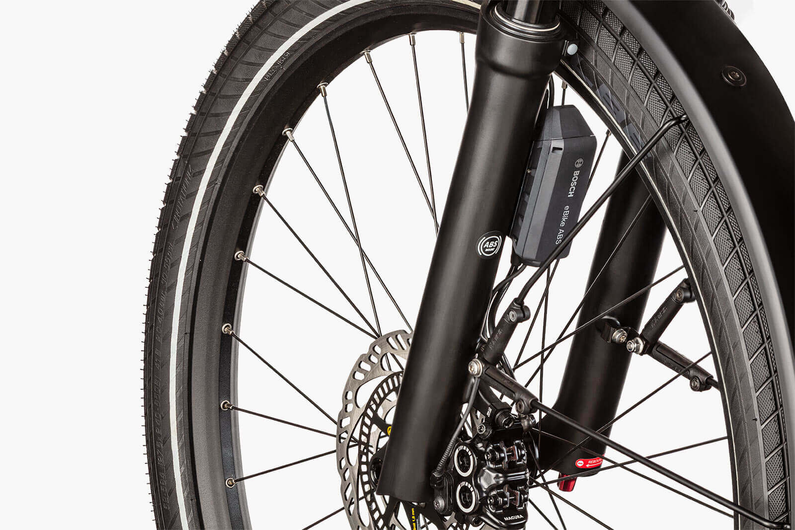 Close-up of Riese & Müller Nevo 4 electric bike front wheel featuring Bosch ABS braking system