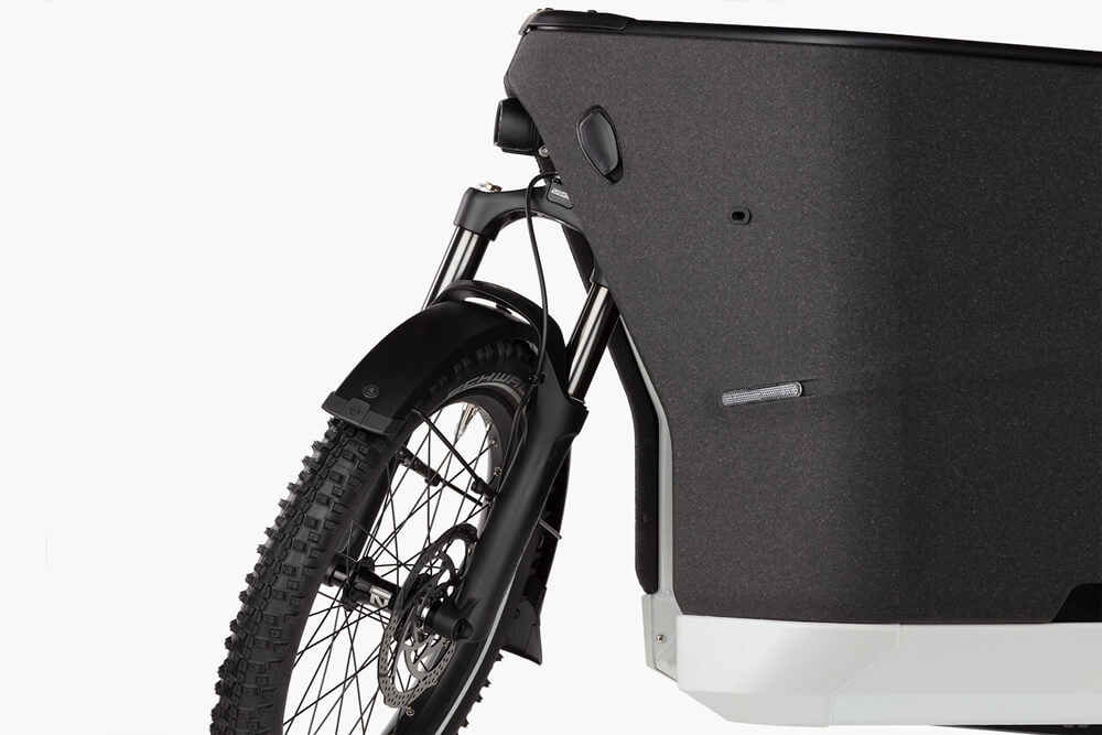 Close-up of the front wheel and cargo section of the Riese & Müller Packster 70 Touring electric bike