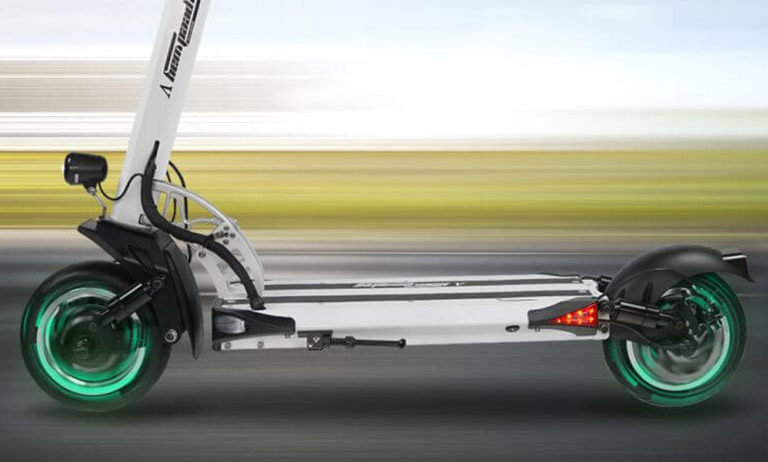 Electric scooter speedway 5 dual motors Speedway 5 electric scooter on the move – dual motors with green glowing wheels in motion