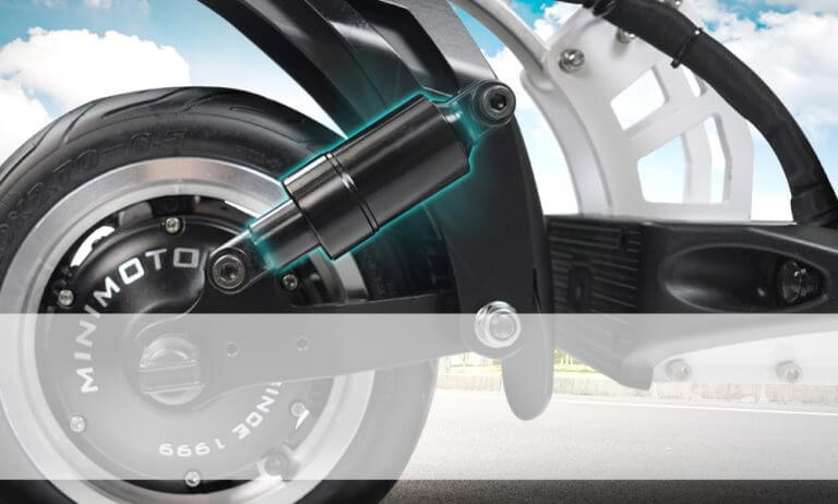 Electric scooter speedway 5 dual suspension Close-up of Speedway 5 rear dual suspension system with visible shock absorber and motor hub