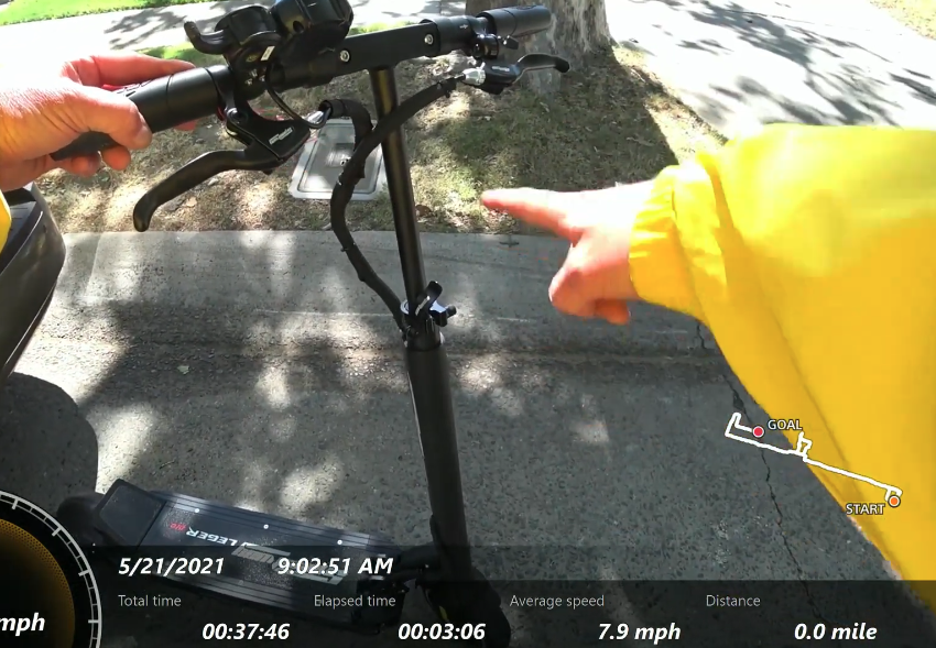 Electric scooter Speedway Leger Pro video thumbnail where mans hand is pointing at the scooters handlebar.