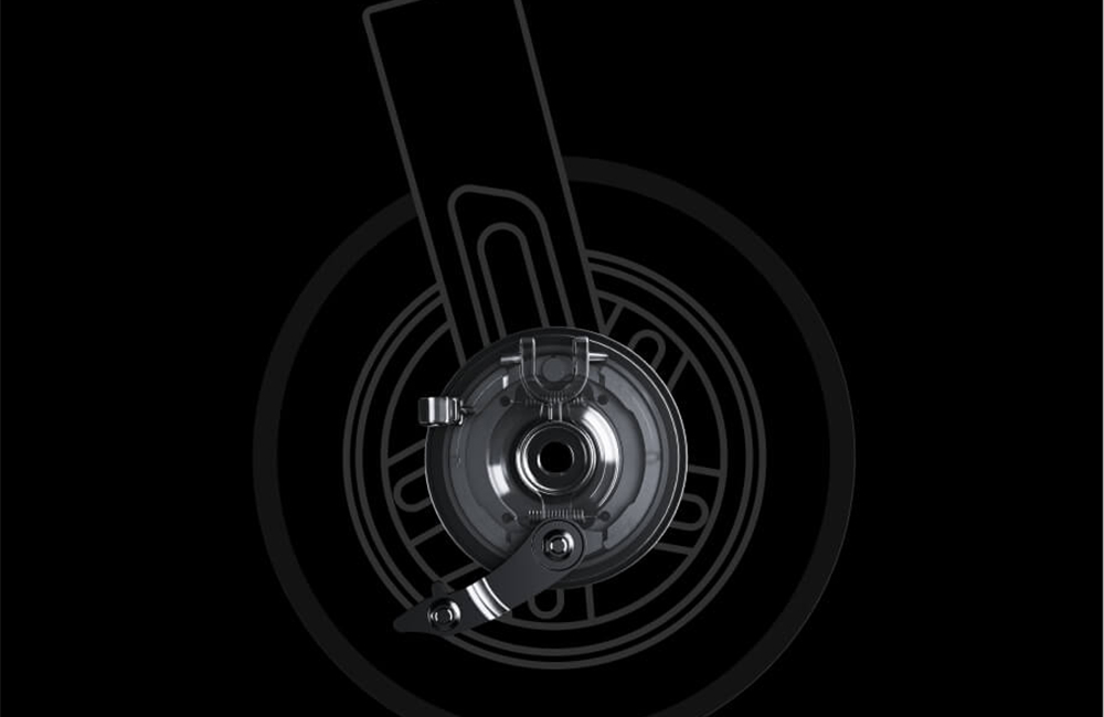 Close-up image of the Segway-Ninebot E2 Pro E electric scooter’s front wheel braking mechanism, showing a detailed view of the drum brake assembly against a dark background.