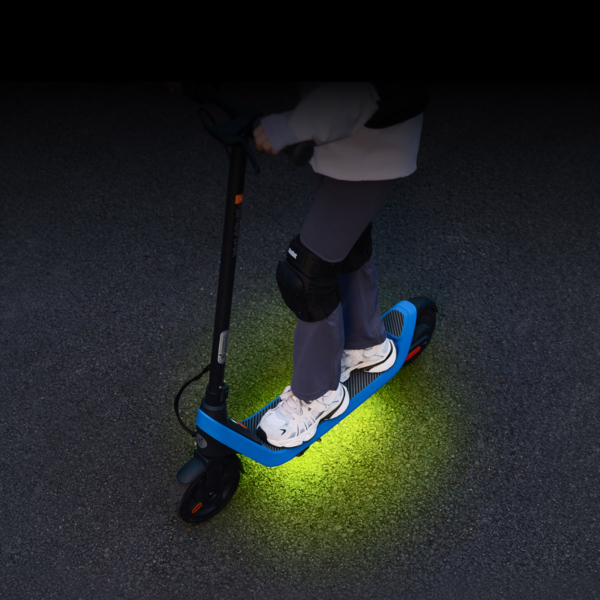 Front light system of the electric scooter Segway C2 Lite illuminated in low light, emphasizing night-time visibility and safety.