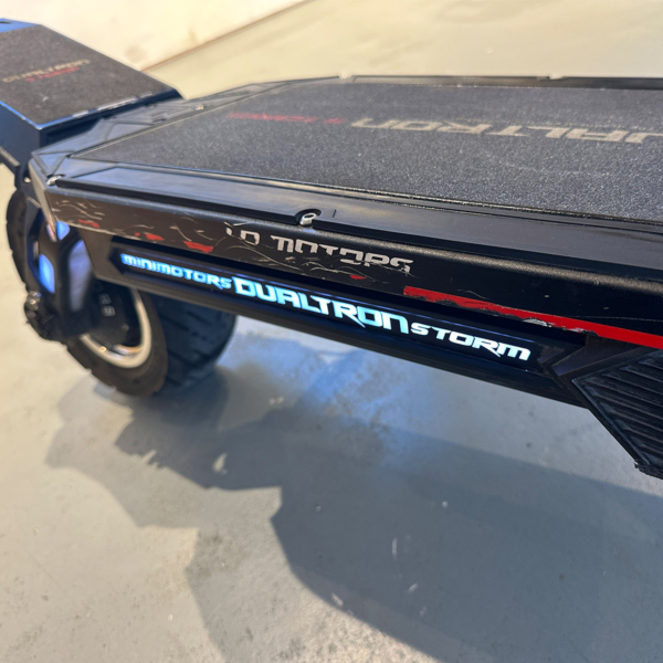 Close-up of used Dualtron Storm electric scooter deck with visible grip wear and surface texture