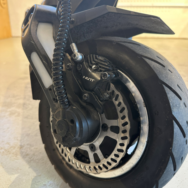 Front wheel of used Dualtron Storm electric scooter with suspension and tire condition visible