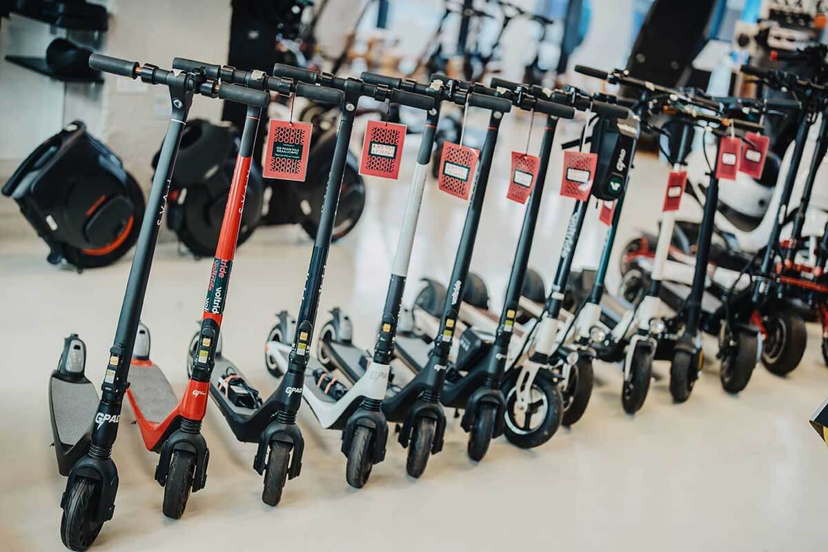 Ex-demo and pre-owned electric scooters on sale with price discount tags in Voltride showroom.