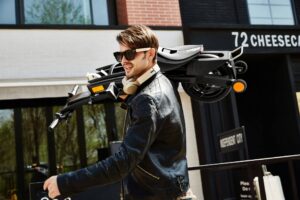 Man carrying the Stigo electric bike.