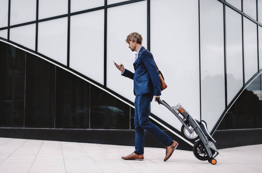 Man walking with the Stigo electric bike on the street.