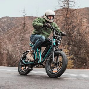 Man riding the Engwe M20 electric bicycle on a road in the mountains wearing a full face helmet.