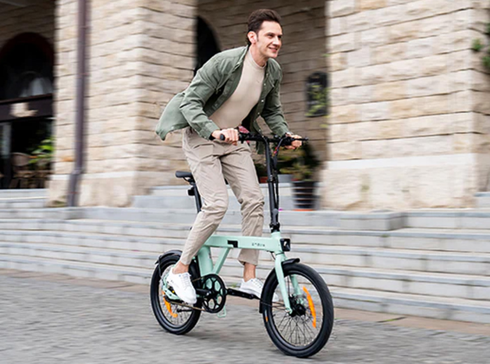 Engwe P20 mint electric bike man riding outdoors Man riding the mint Engwe P20 electric bike in an upright position outdoors
