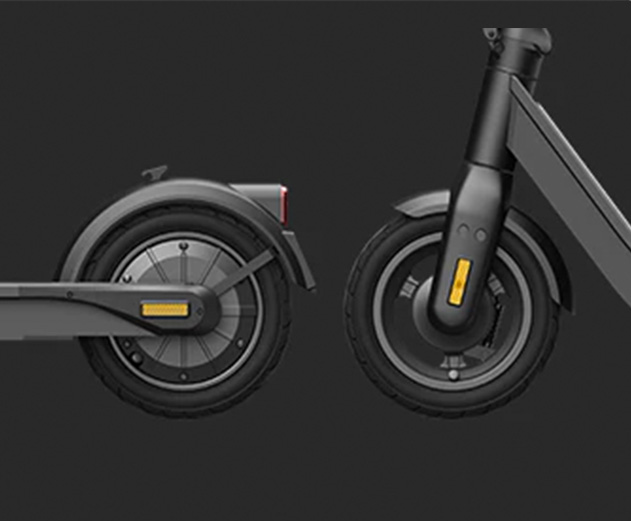 Close-up of the Inmotion Air electric scooter's rear solid and front hollow tires.