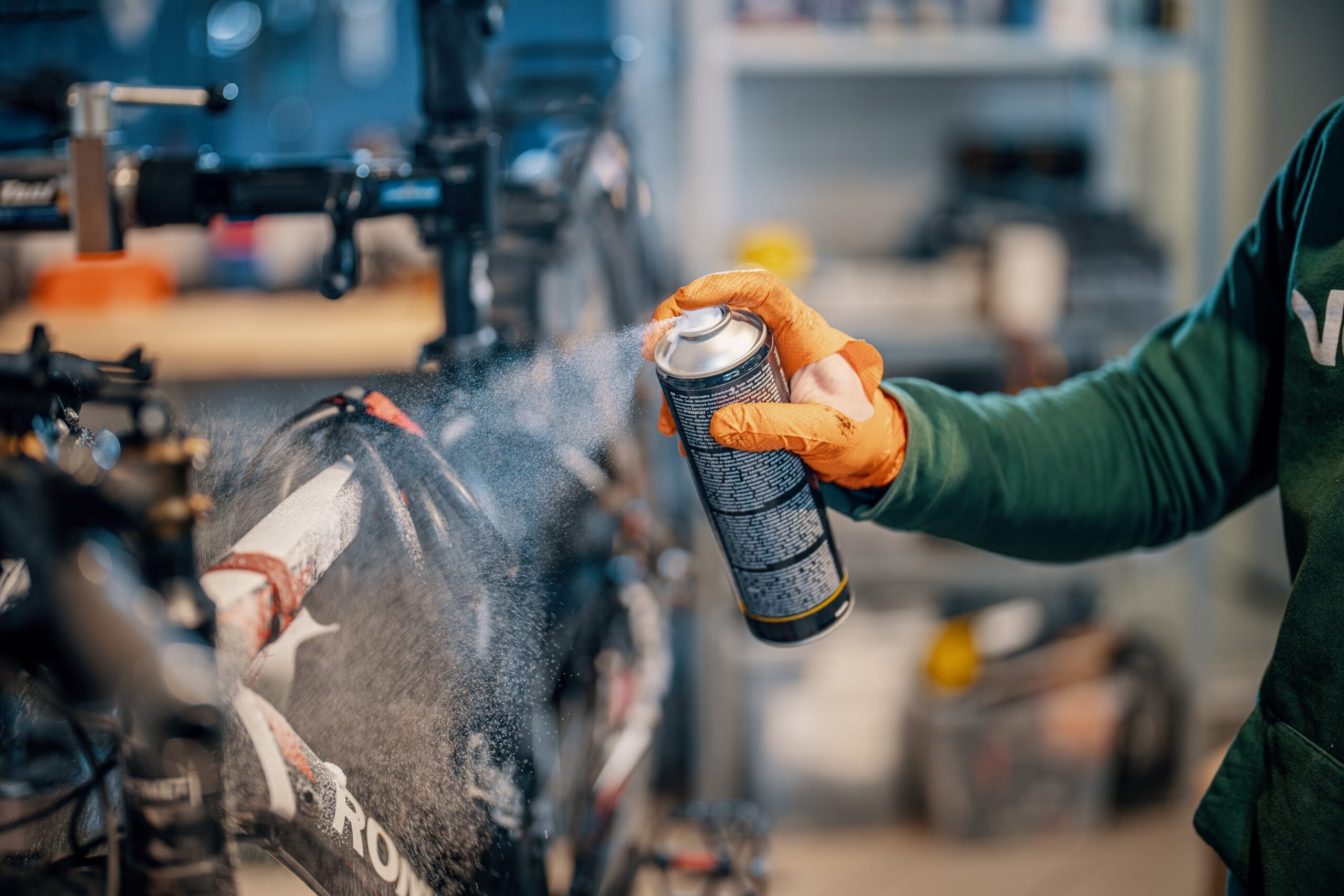Electric bicycle maintenance blog image Close-up of bike cleaning process with spray applied to frame and components