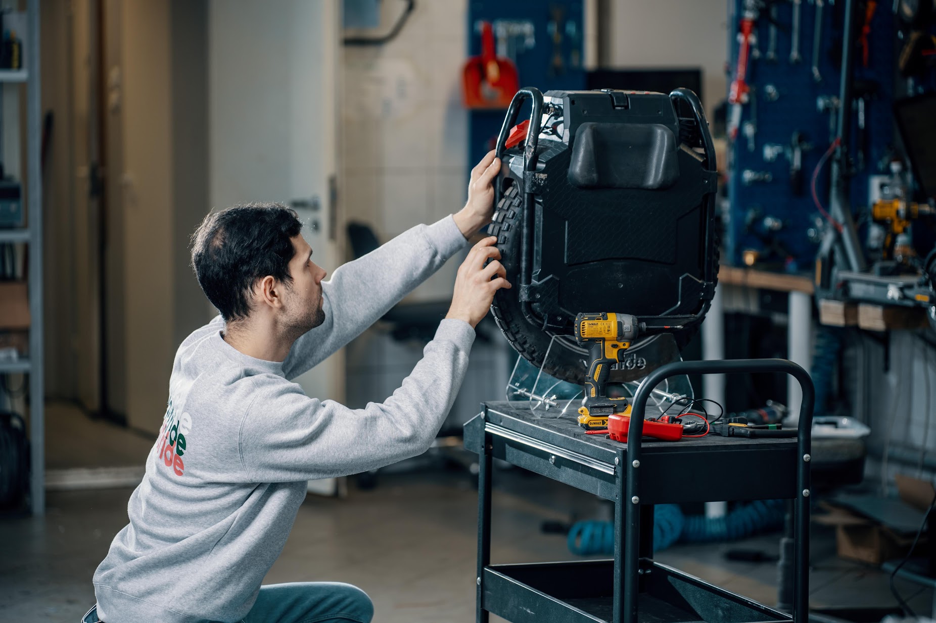 Electric unicycle maintenance blog image 2 Technician repairing an electric unicycle in a workshop