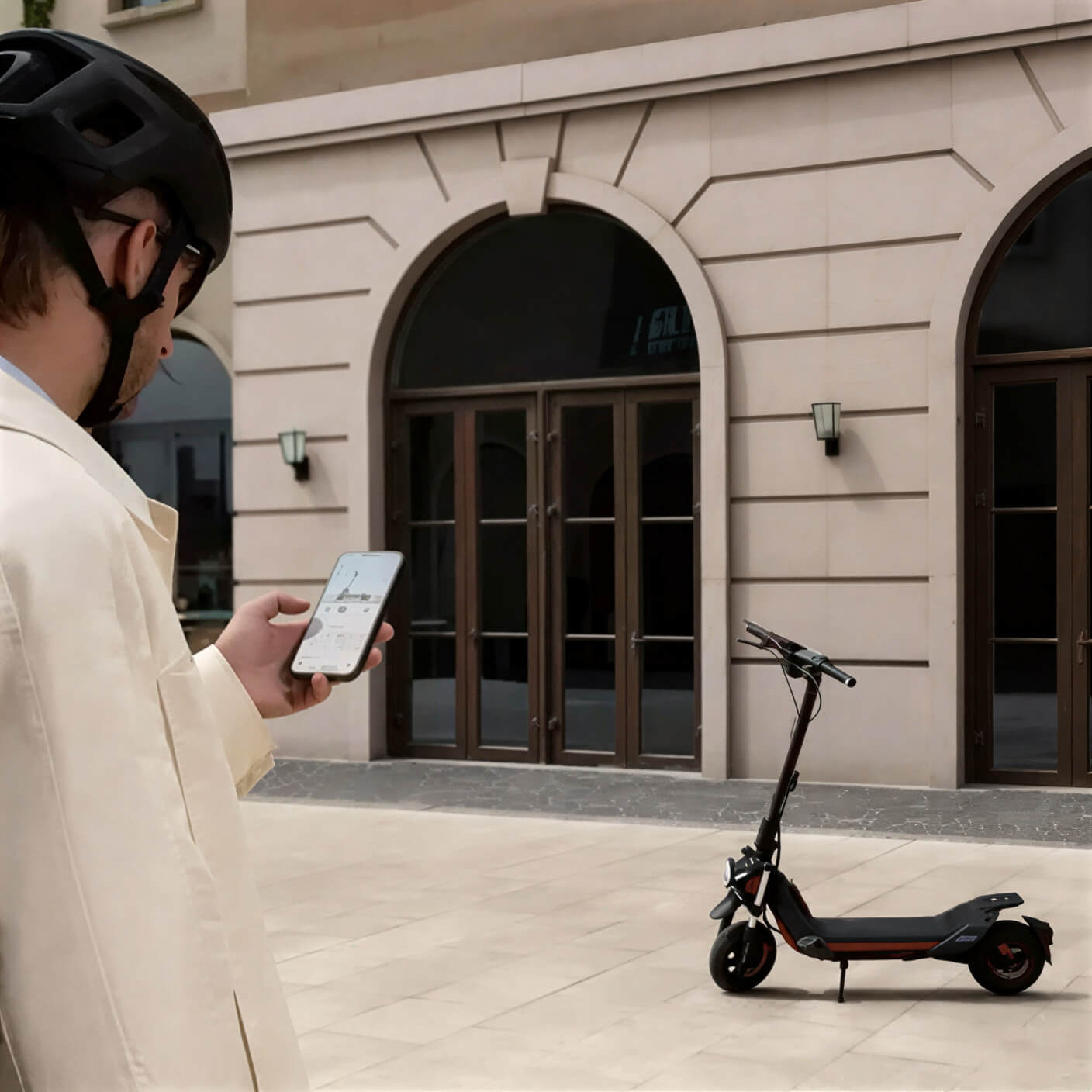 Segway-Ninebot ZT3 Pro E smart features lifestyle Person using a smartphone app while standing next to the Segway-Ninebot ZT3 Pro E electric scooter in a modern urban courtyard.