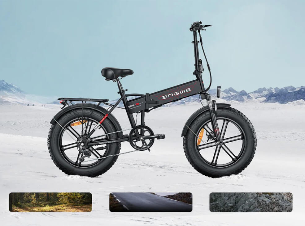 Black ENGWE EP-2 Pro foldable fat-tire electric bike shown in side view on a snowy landscape, featuring wide tires, front suspension, rear cargo rack, and a compact folding frame.