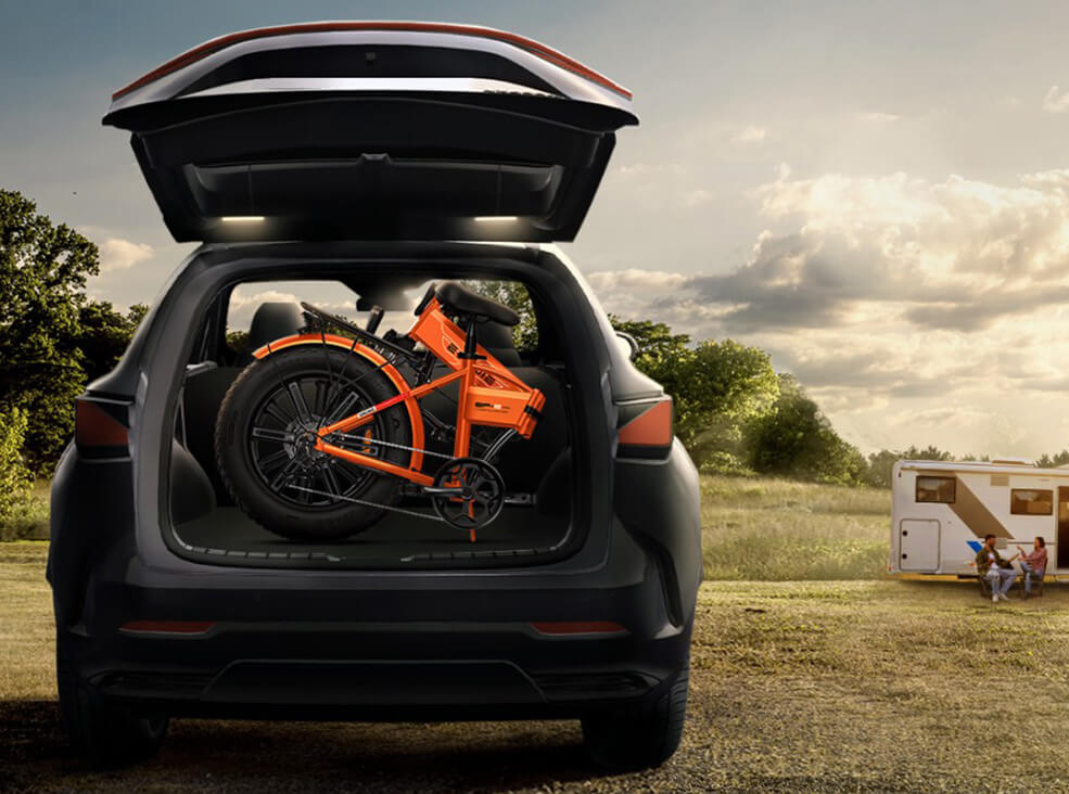 Orange ENGWE EP-2 Pro foldable fat-tire electric bike folded and stored in the trunk of an SUV, highlighting its compact design and easy transport for travel and outdoor adventures.