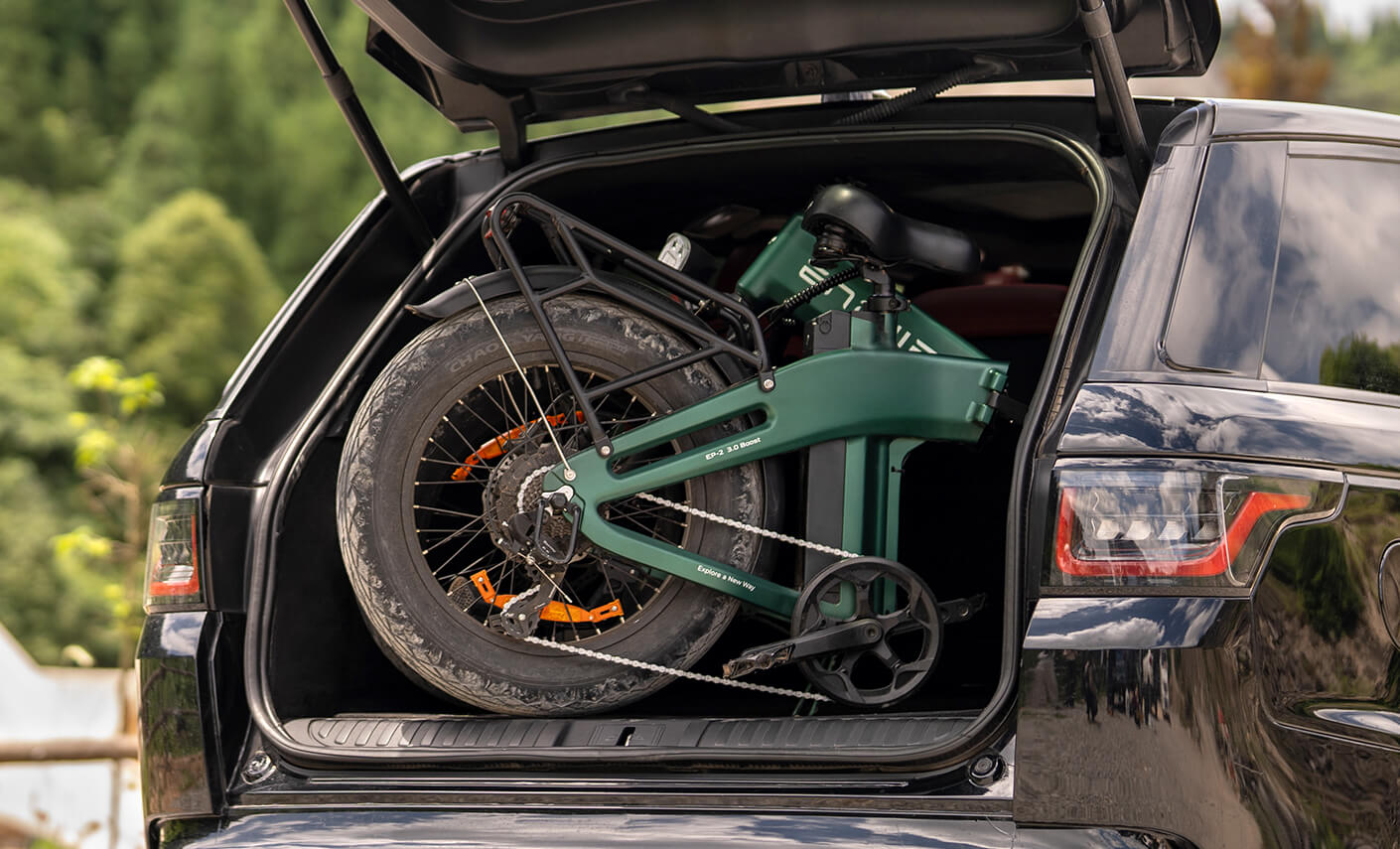 Folded Engwe EP-2 3.0 Boost electric bike packed inside a car's trunk, demonstrating its compact folding design for easy transport and storage.