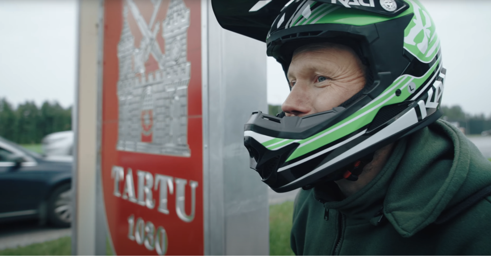 Close-up of Mart next to Tartu sign after riding the electric unicycle Gotway Monster Pro from Tallinn to Tartu.