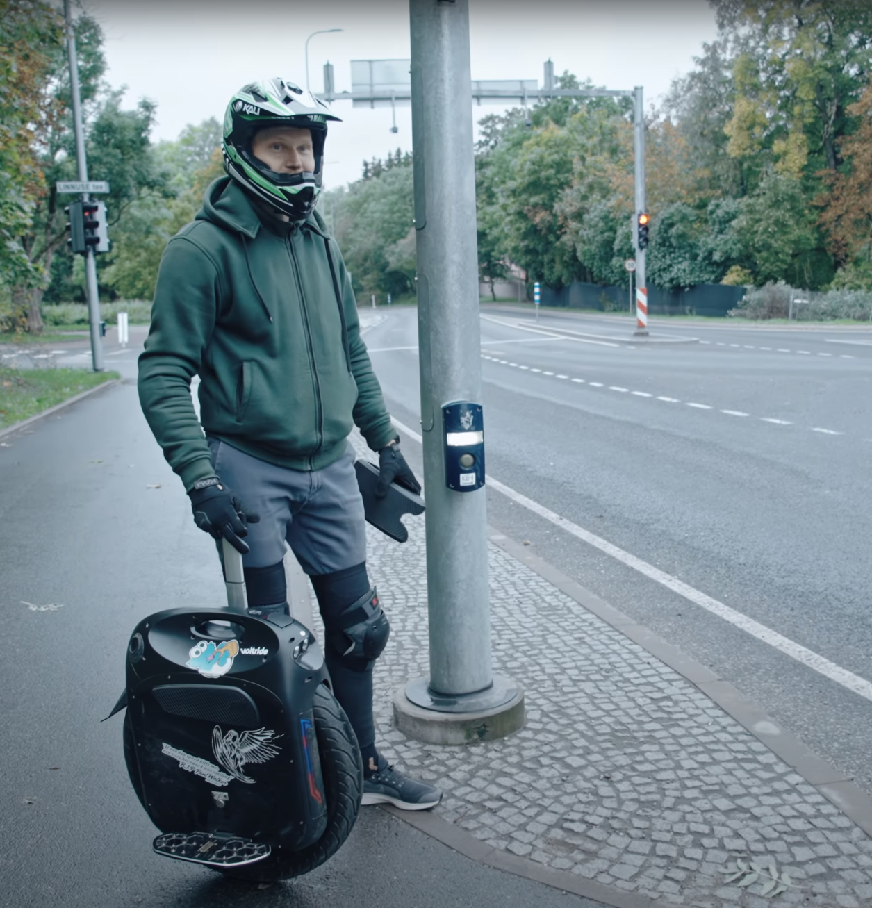 Mart standing next to the electric unicycle Gotway Monster Pro before starting the ride.